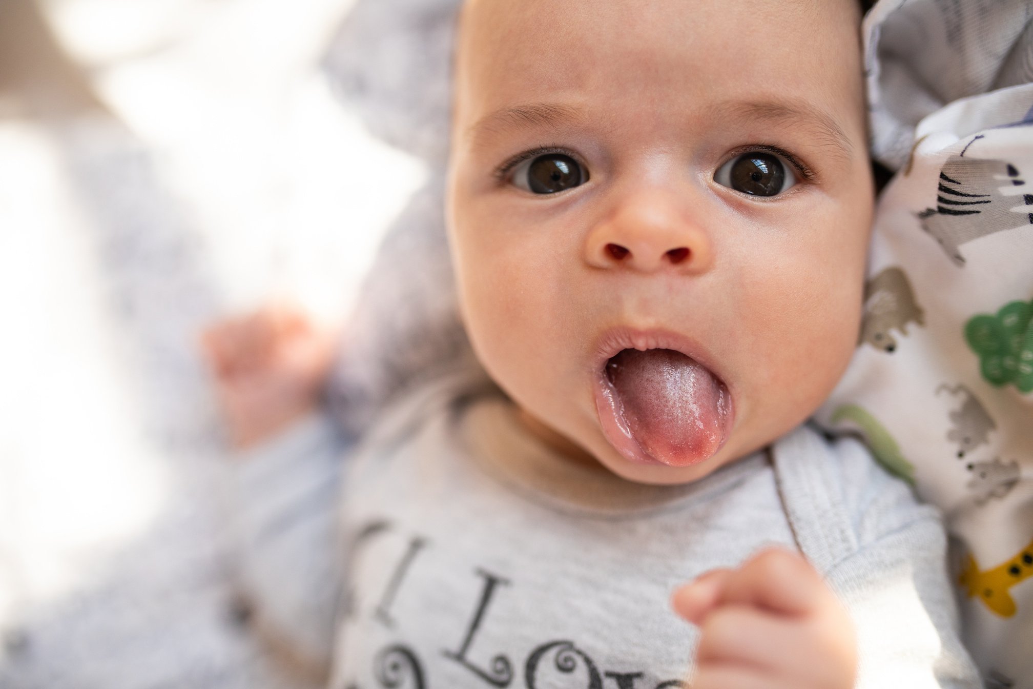 Baby sticking out his tongue